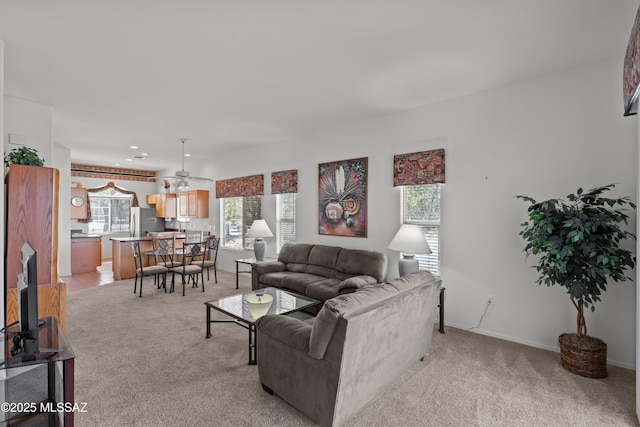 living room featuring light carpet and ceiling fan
