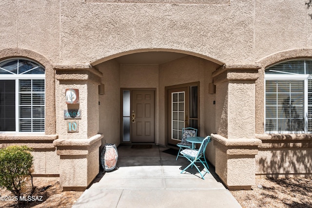 entrance to property with stucco siding