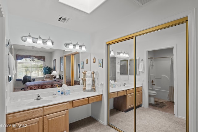 bathroom with vanity, toilet, connected bathroom, and visible vents