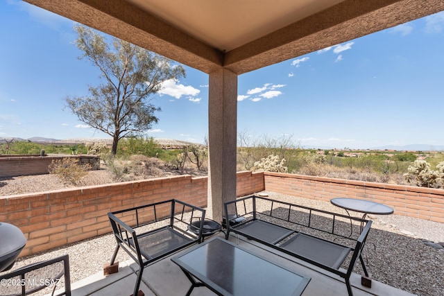view of patio with a mountain view and a fenced backyard