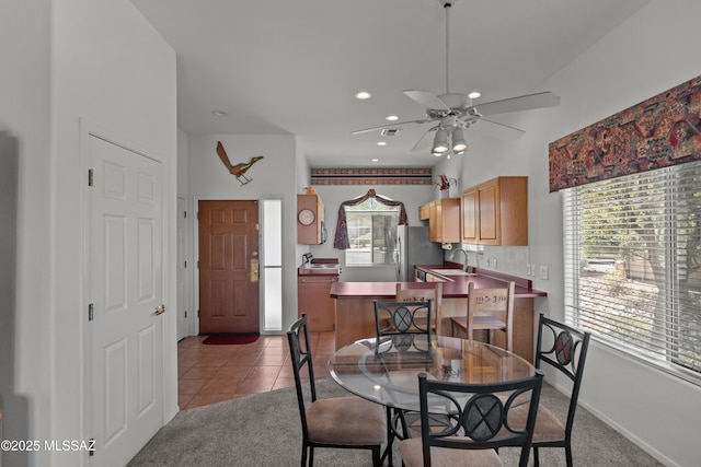 dining room with a ceiling fan, light tile patterned floors, recessed lighting, and light colored carpet