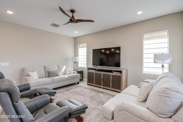 living room with carpet floors, recessed lighting, ceiling fan, and visible vents