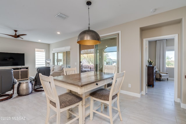 dining space with visible vents, baseboards, ceiling fan, and a healthy amount of sunlight