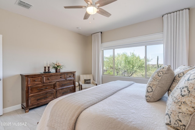 bedroom with visible vents, baseboards, ceiling fan, and light tile patterned floors