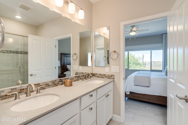 ensuite bathroom with a sink, ensuite bathroom, ceiling fan, and visible vents