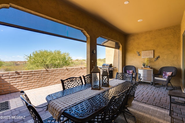 view of patio with area for grilling and outdoor dining space