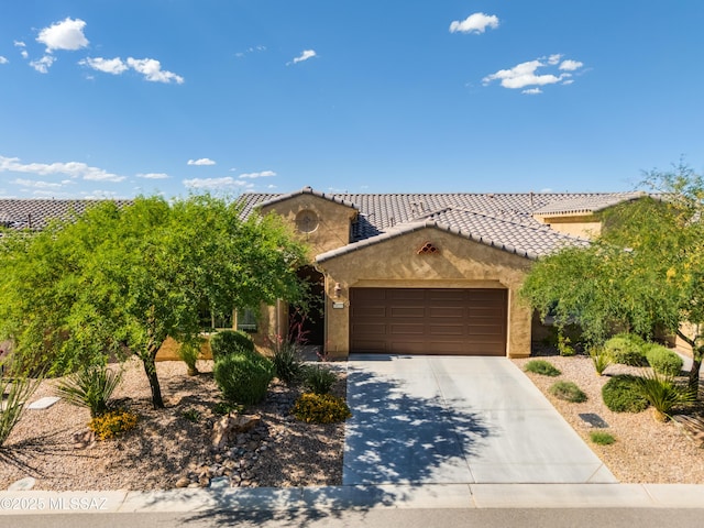 mediterranean / spanish-style house featuring a garage, stucco siding, driveway, and a tile roof