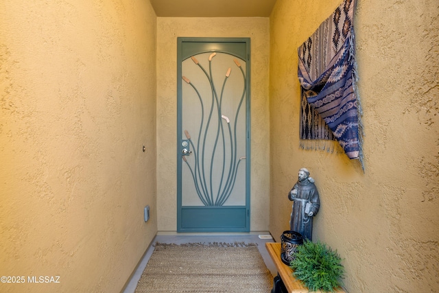 property entrance featuring stucco siding