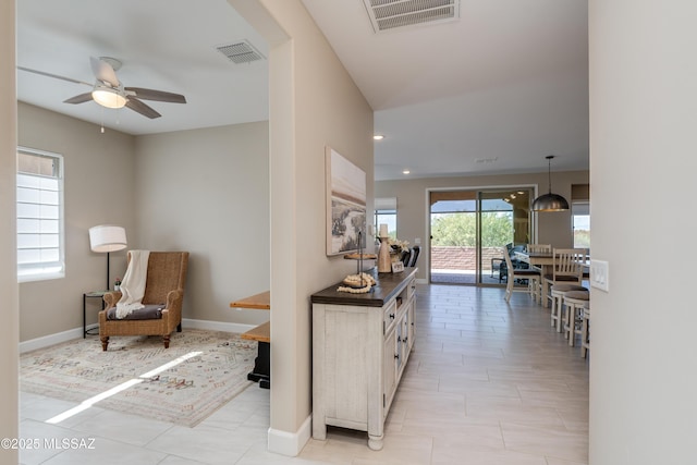 corridor featuring baseboards, recessed lighting, and visible vents