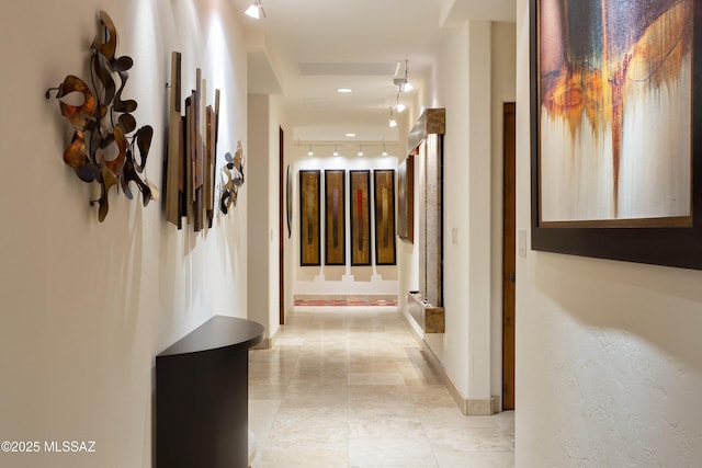 hallway featuring baseboards and visible vents