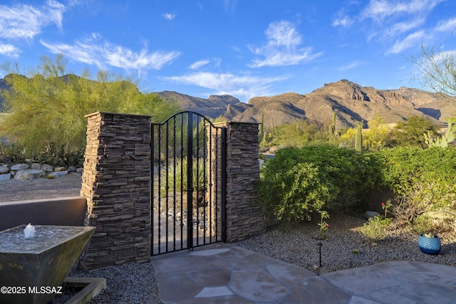 view of gate with a mountain view