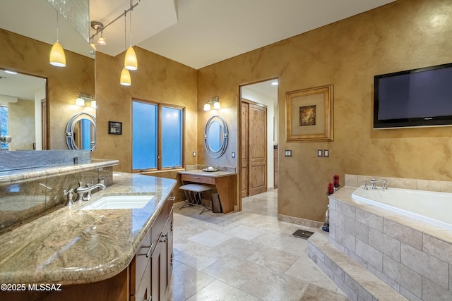 full bathroom featuring baseboards, vanity, and a bath
