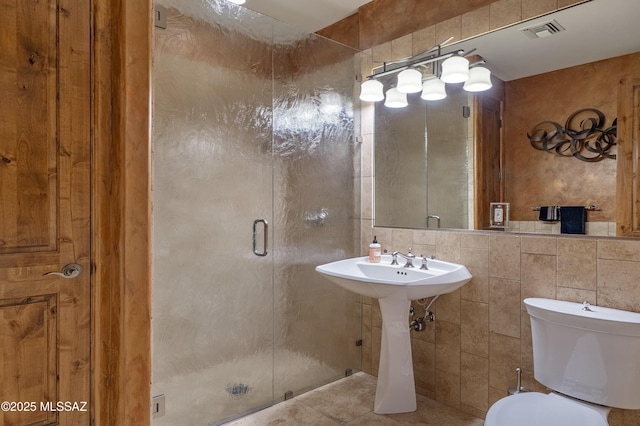 full bathroom with toilet, visible vents, tile patterned flooring, and a stall shower