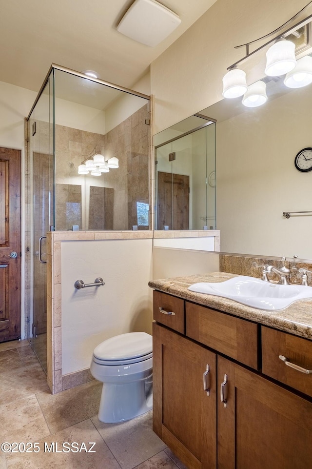 full bath with vanity, toilet, and a stall shower
