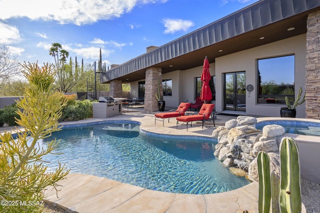 view of swimming pool featuring a fenced in pool, a patio area, and area for grilling