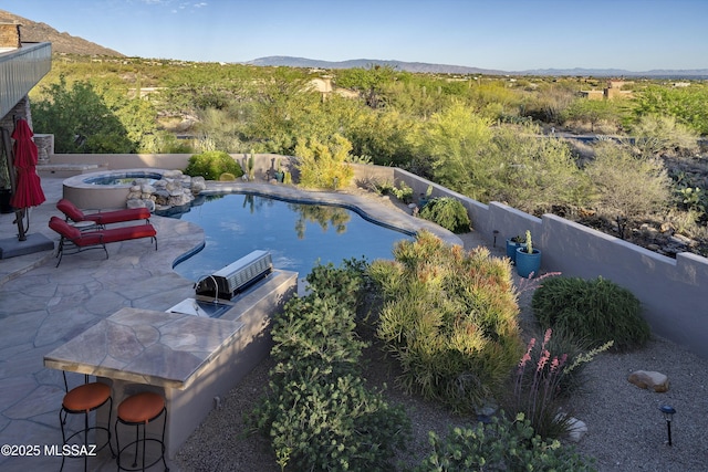 view of swimming pool with a fenced backyard, a fenced in pool, a mountain view, an in ground hot tub, and a patio