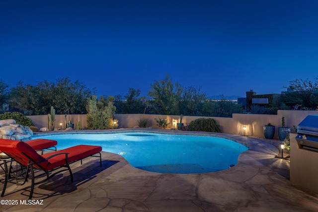 pool at twilight with a fenced backyard, a fenced in pool, and a patio area