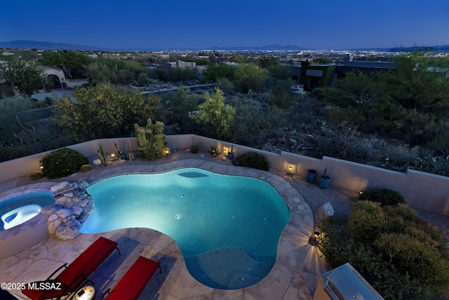 view of pool with a fenced backyard, a fenced in pool, and an in ground hot tub
