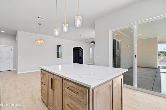 kitchen with light tile patterned floors, visible vents, a kitchen island, arched walkways, and hanging light fixtures