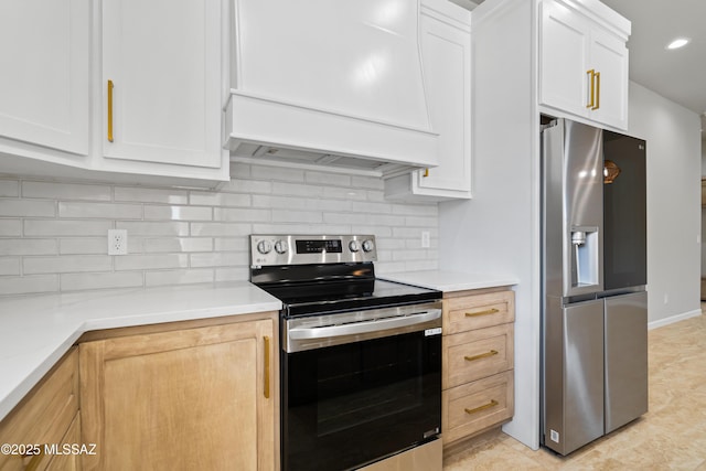 kitchen with custom range hood, white cabinetry, backsplash, light countertops, and appliances with stainless steel finishes