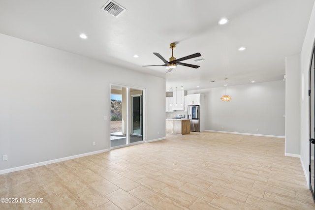 unfurnished living room featuring baseboards, visible vents, a ceiling fan, and recessed lighting