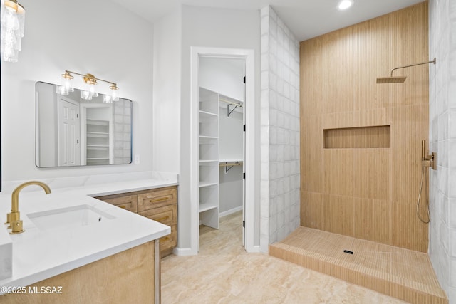 full bath featuring a walk in closet, recessed lighting, walk in shower, and vanity