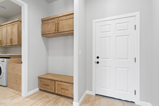 mudroom featuring visible vents, washer / dryer, and baseboards