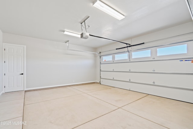 garage with baseboards and a garage door opener