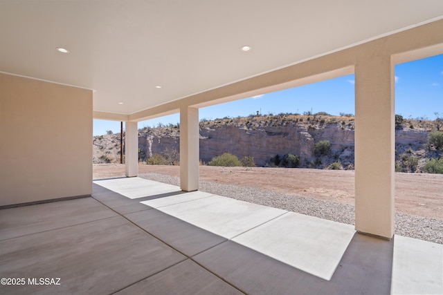 view of patio with fence and a mountain view
