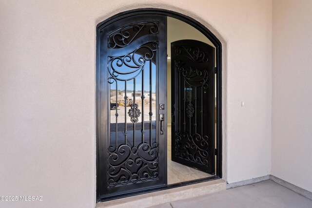 doorway to property featuring stucco siding