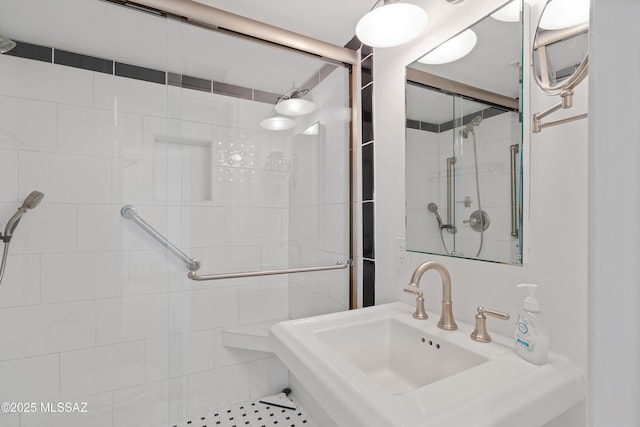 bathroom featuring a sink and a stall shower