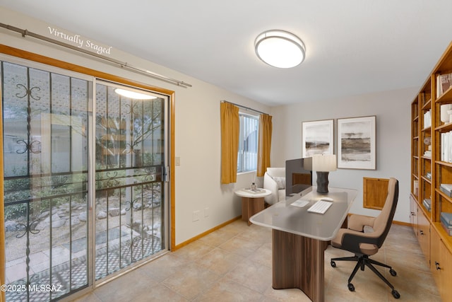 home office with light tile patterned flooring and baseboards