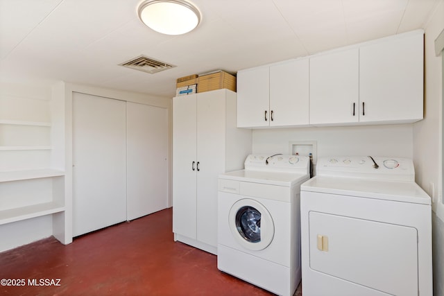 laundry room with visible vents, cabinet space, and independent washer and dryer
