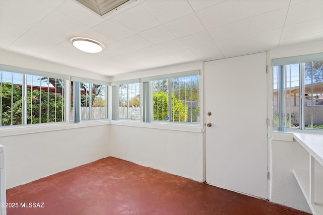 unfurnished sunroom featuring finished concrete flooring