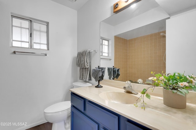 full bathroom featuring vanity, wood finished floors, and toilet