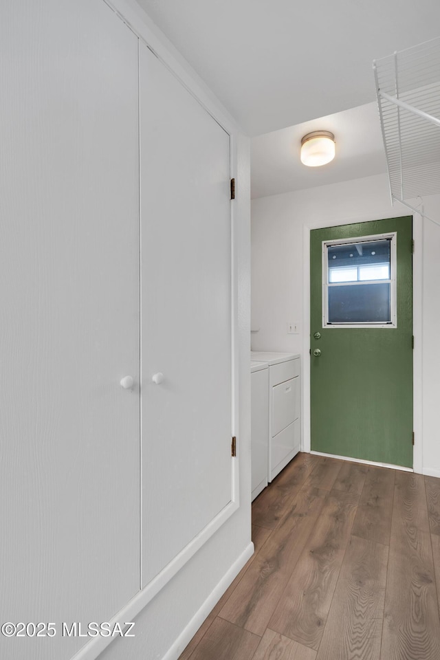 clothes washing area featuring laundry area, dark wood-style flooring, and washing machine and dryer