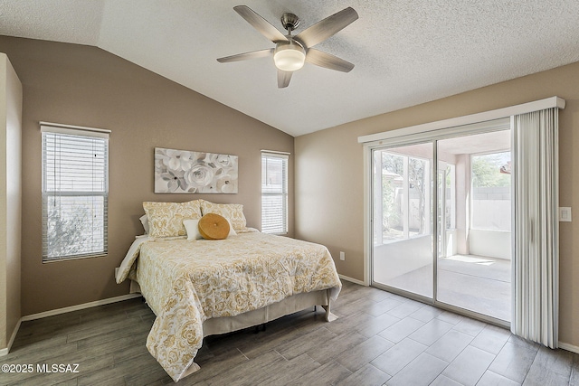 bedroom with vaulted ceiling, access to exterior, and wood finished floors