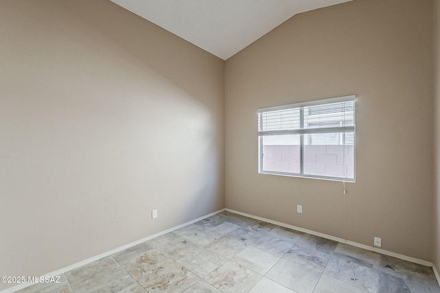 unfurnished room with lofted ceiling and baseboards