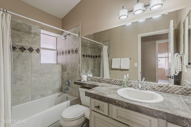 full bath with a wealth of natural light, toilet, vanity, and shower / tub combo