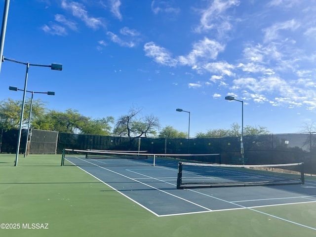 view of sport court featuring fence