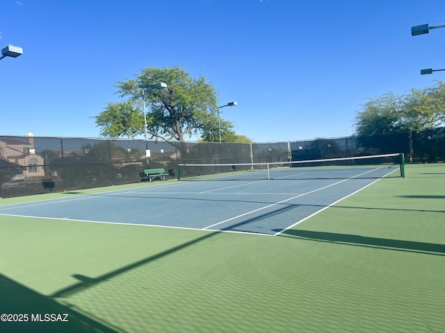 view of tennis court with fence and community basketball court