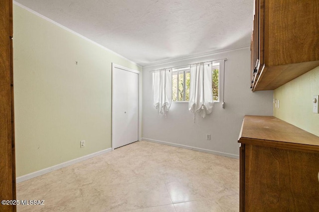 spare room featuring baseboards and ornamental molding