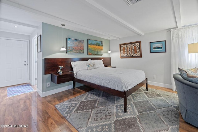 bedroom with visible vents, wood finished floors, beamed ceiling, baseboards, and recessed lighting