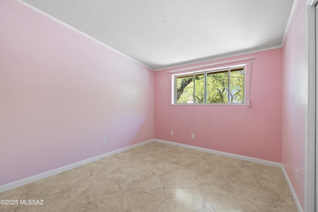 unfurnished room featuring crown molding and baseboards