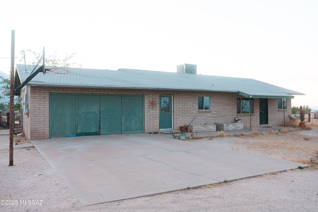 1350 E Goosetree Ln, Safford, AZ 85546 - back of property featuring a garage, a chimney, driveway, and brick siding