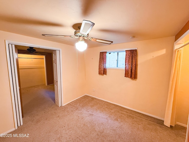 1350 E Goosetree Ln, Safford, AZ 85546 - unfurnished bedroom featuring light colored carpet, a ceiling fan, and baseboards