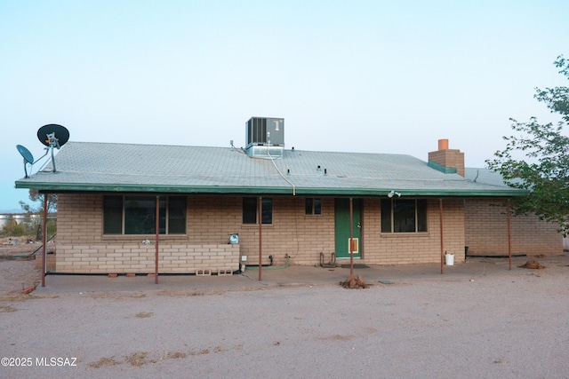 1350 E Goosetree Ln, Safford, AZ 85546 - rear view of house featuring brick siding, central AC, and a chimney