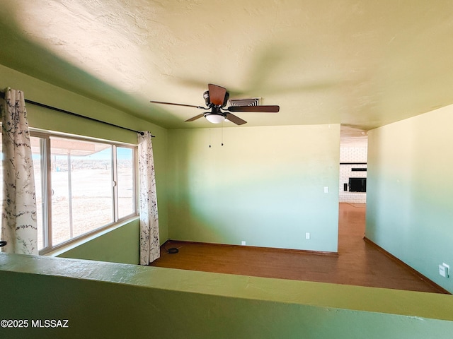 1350 E Goosetree Ln, Safford, AZ 85546 - unfurnished room featuring a ceiling fan, baseboards, visible vents, and wood finished floors