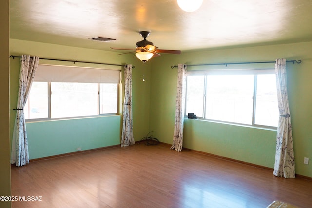 1350 E Goosetree Ln, Safford, AZ 85546 - unfurnished room with visible vents, a ceiling fan, baseboards, and wood finished floors