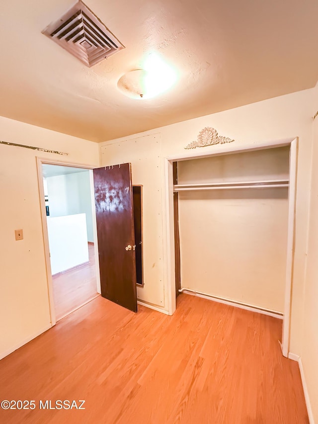 1350 E Goosetree Ln, Safford, AZ 85546 - unfurnished bedroom with light wood-style floors, a closet, and visible vents